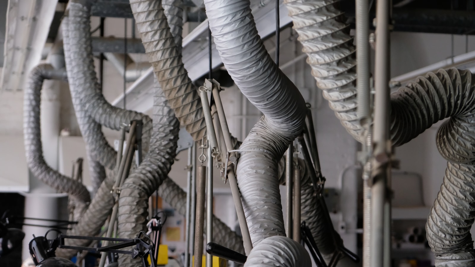 Technician installing ducted heating in a ceiling cavity