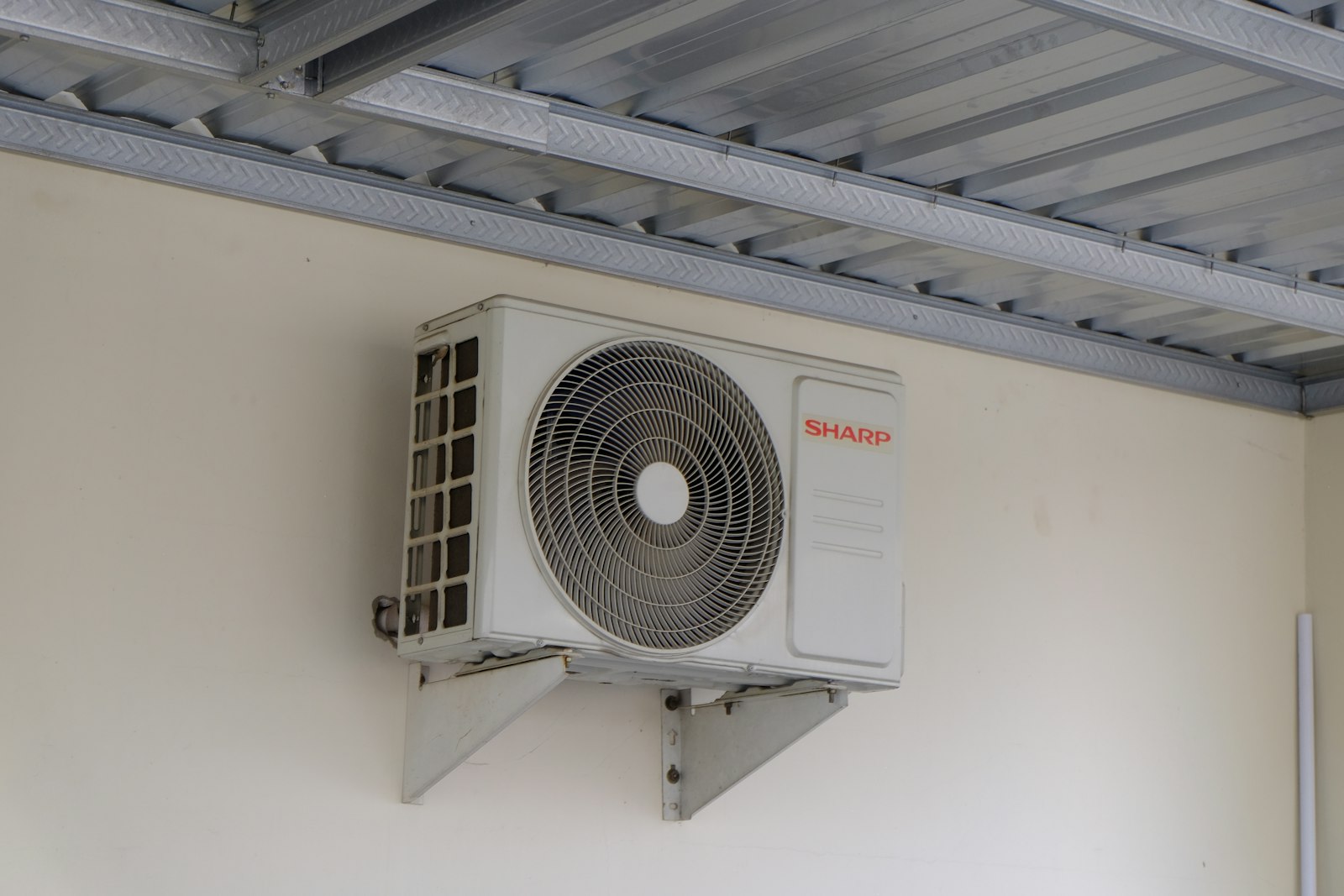 Technician on a ladder installing ducted air conditioning