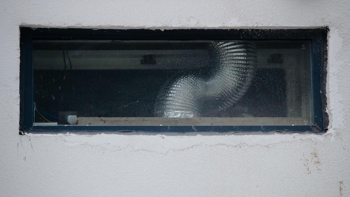 Flexible ducting installed through a residential wall